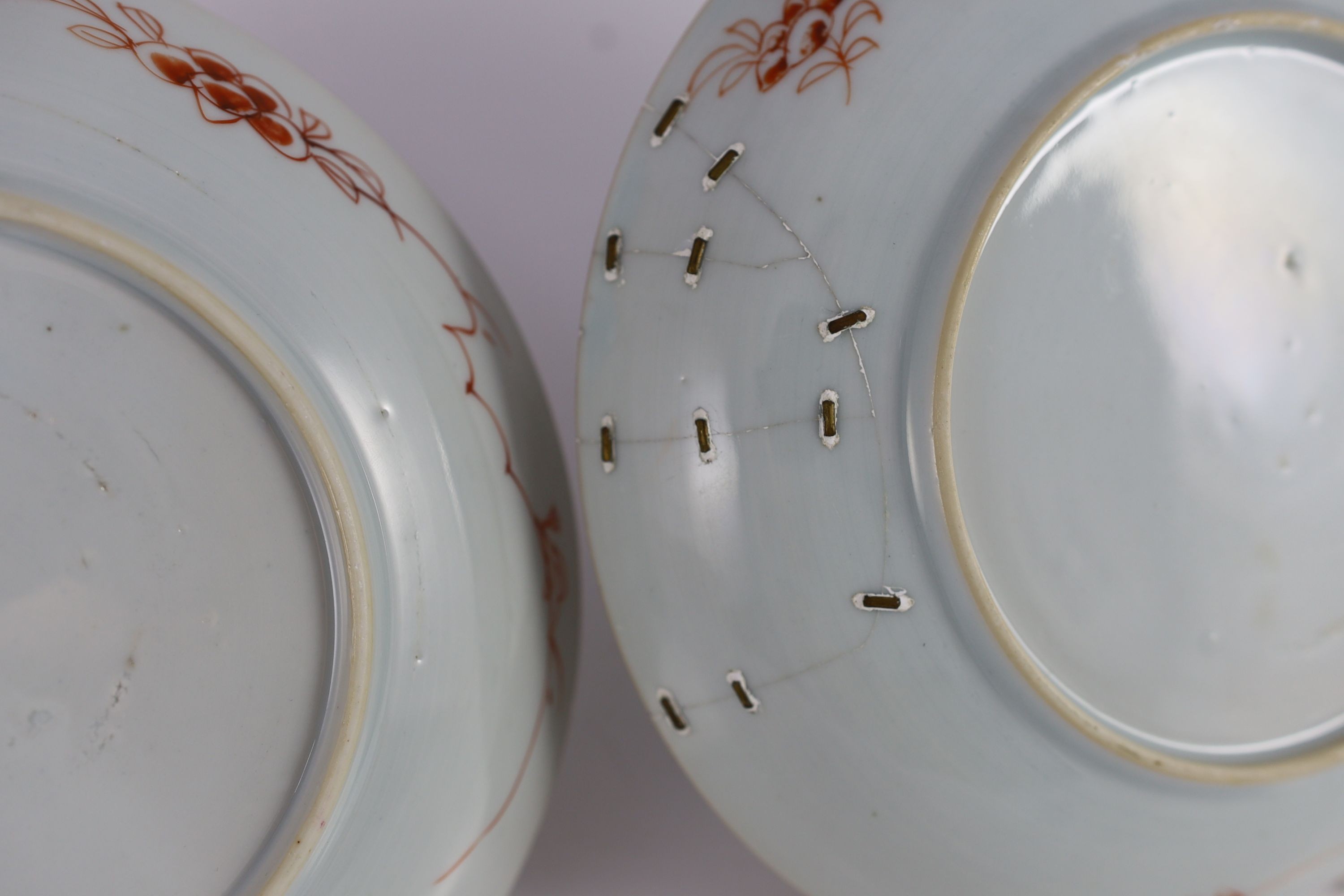A pair of Chinese famille rose dishes, early Qianlong period, 22 cm diameter, one broken and repaired